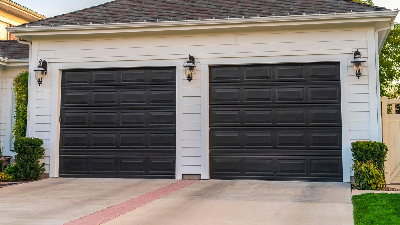 Modern black garage doors installed in Connellsville, PA by Bear Door Services
