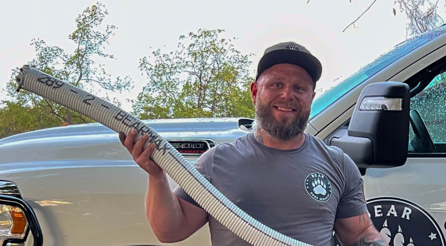 Bear Door Services technician repairing garage door hardware