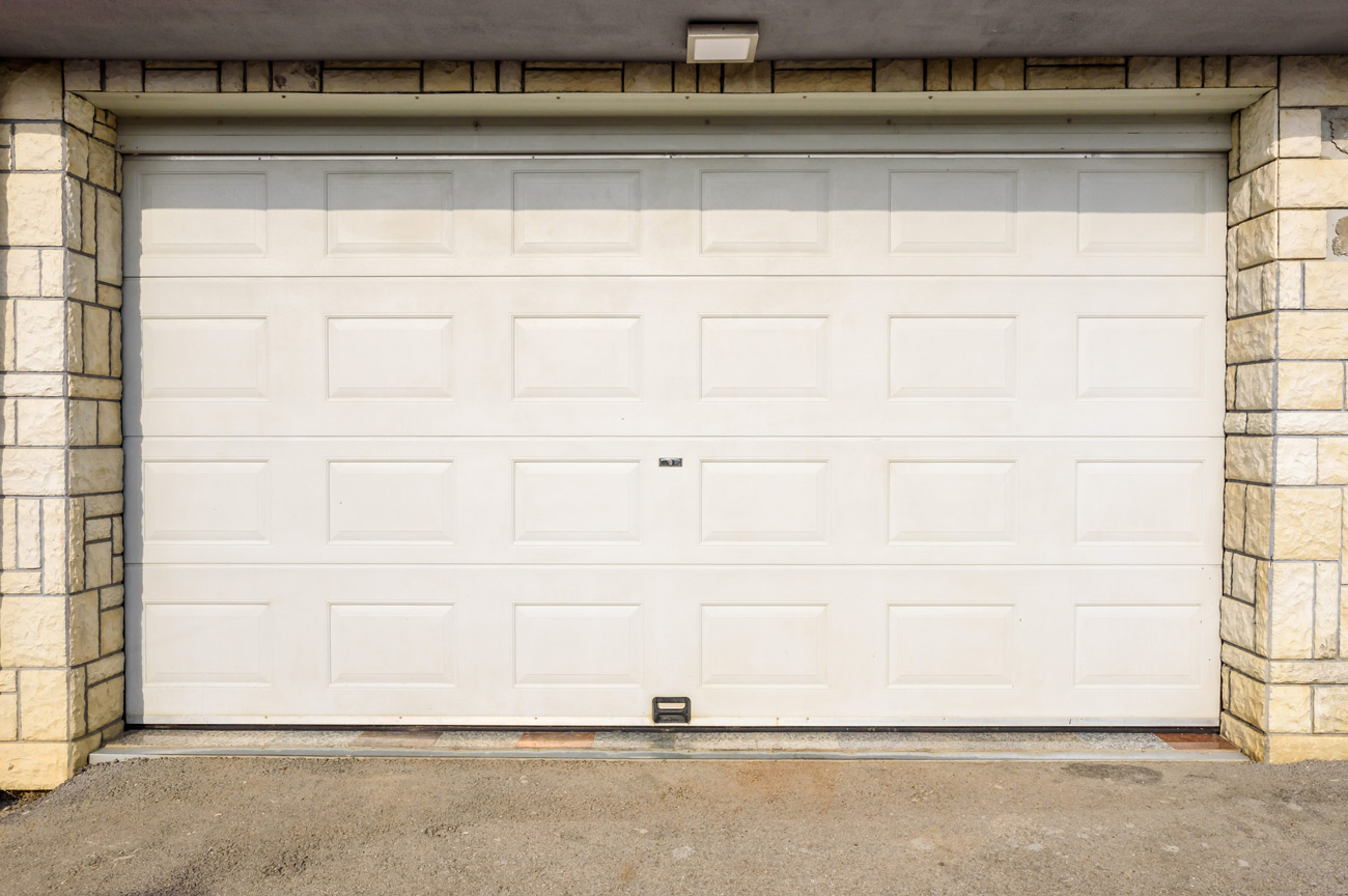 Stone-trim garage door installed in Oliver, PA by Bear Door Services