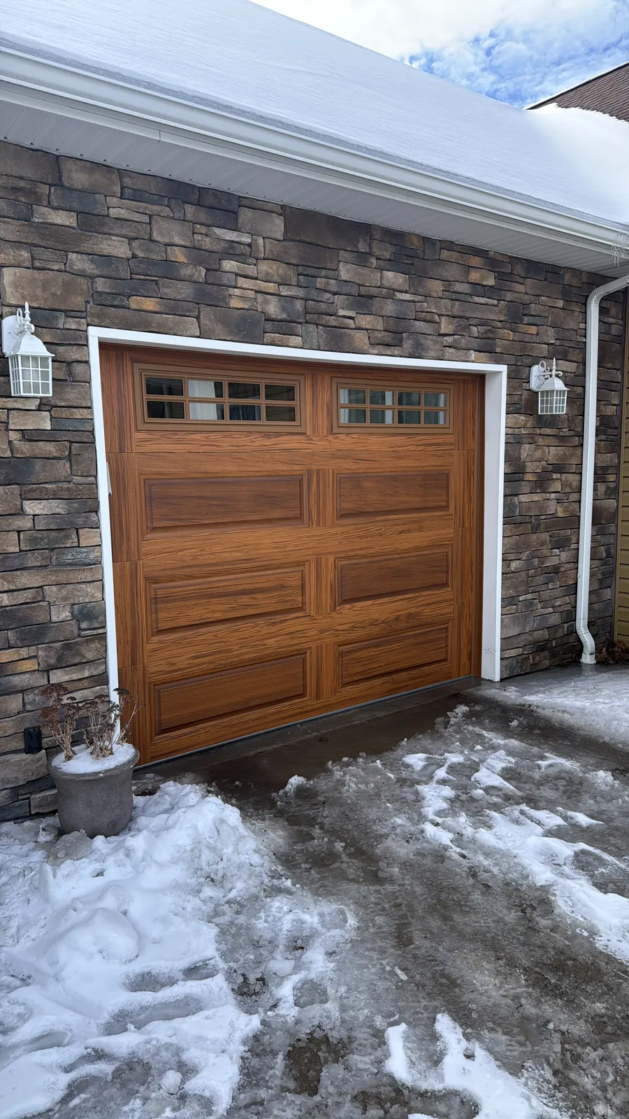 Merv Unger garage after — A full winter curb-appeal refresh with premium insulated woodgrain doors.