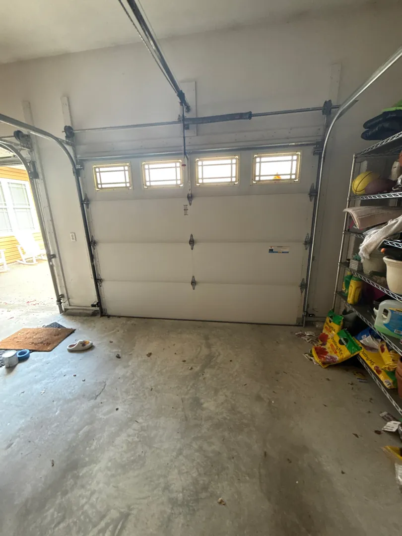 Merv Unger garage before — A full winter curb-appeal refresh with premium insulated woodgrain doors.