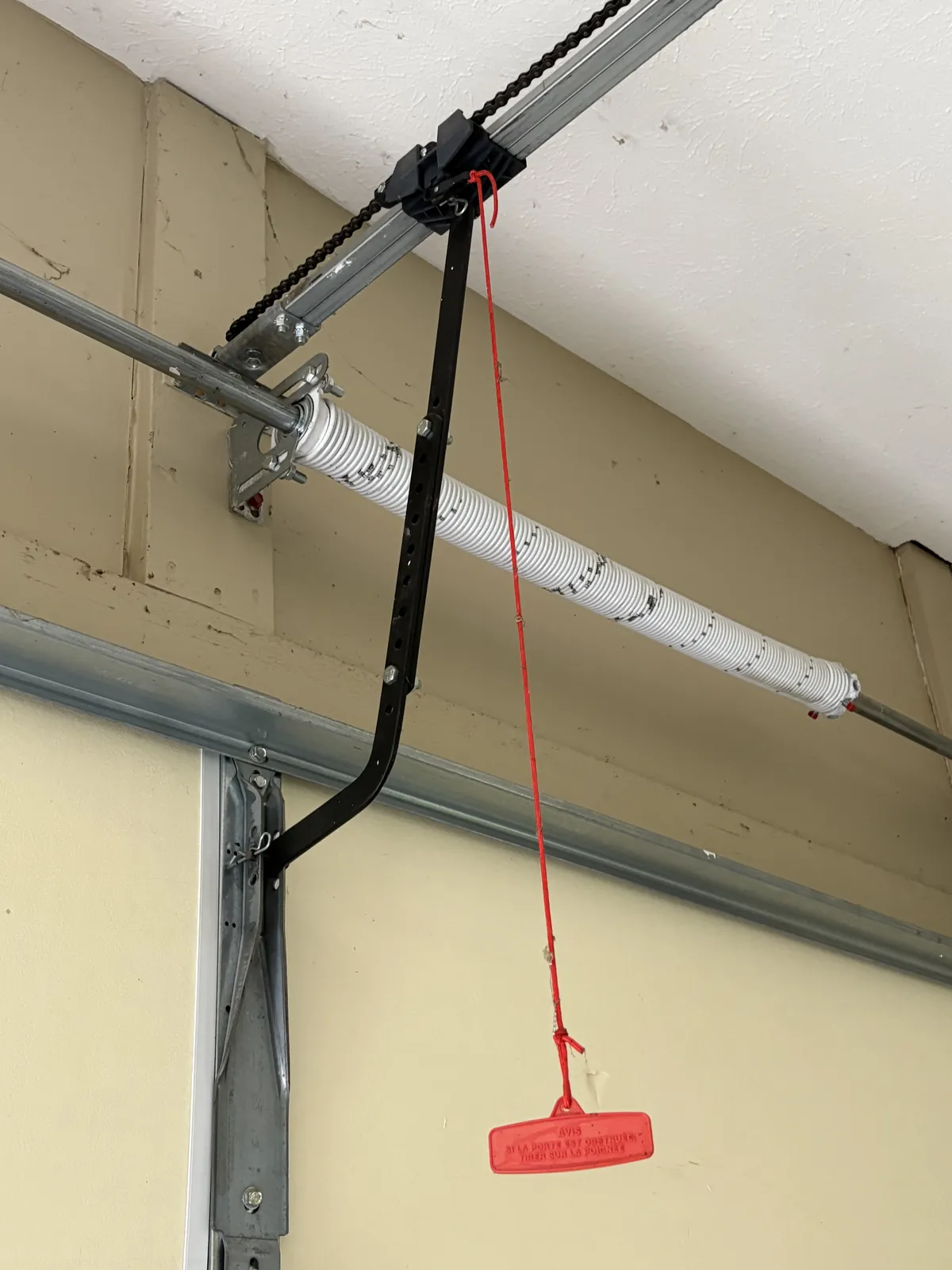 Bear Door Services technician fitting a BEARMAX torsion spring system