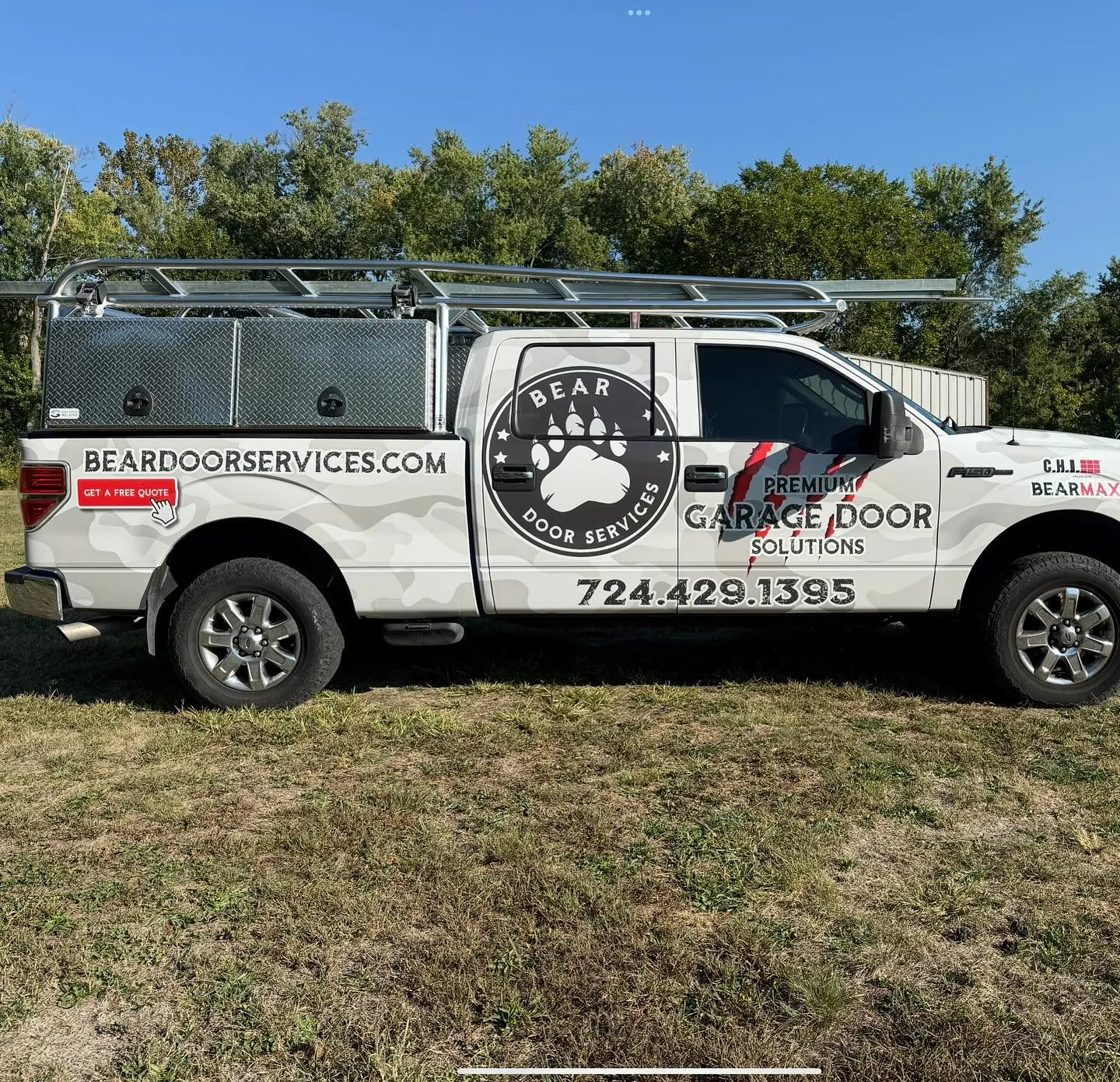 The Bear Door Services branded camo-wrap service truck