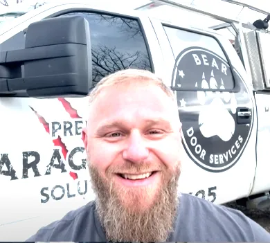 Michael, owner of Bear Door Services, in front of the company truck